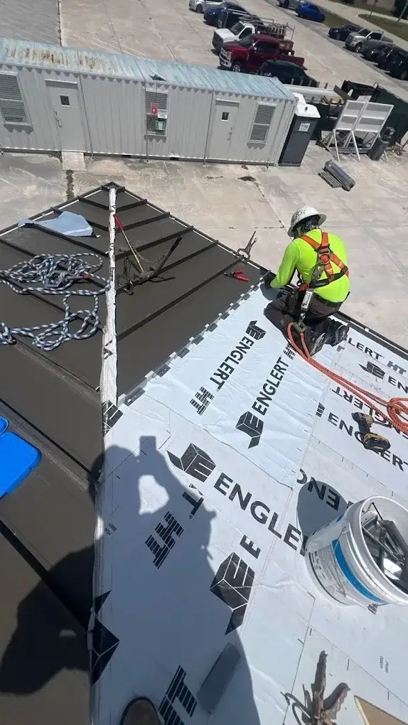 Roofer installing a new metal roof in South Florida for Bob Hilson & Company Roofing
